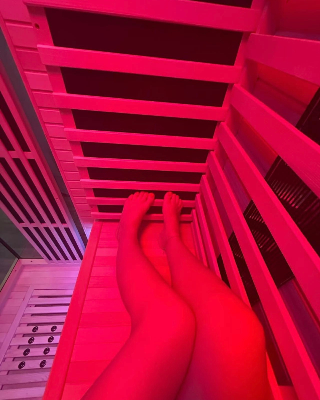 Woman relaxing in a warm infrared sauna